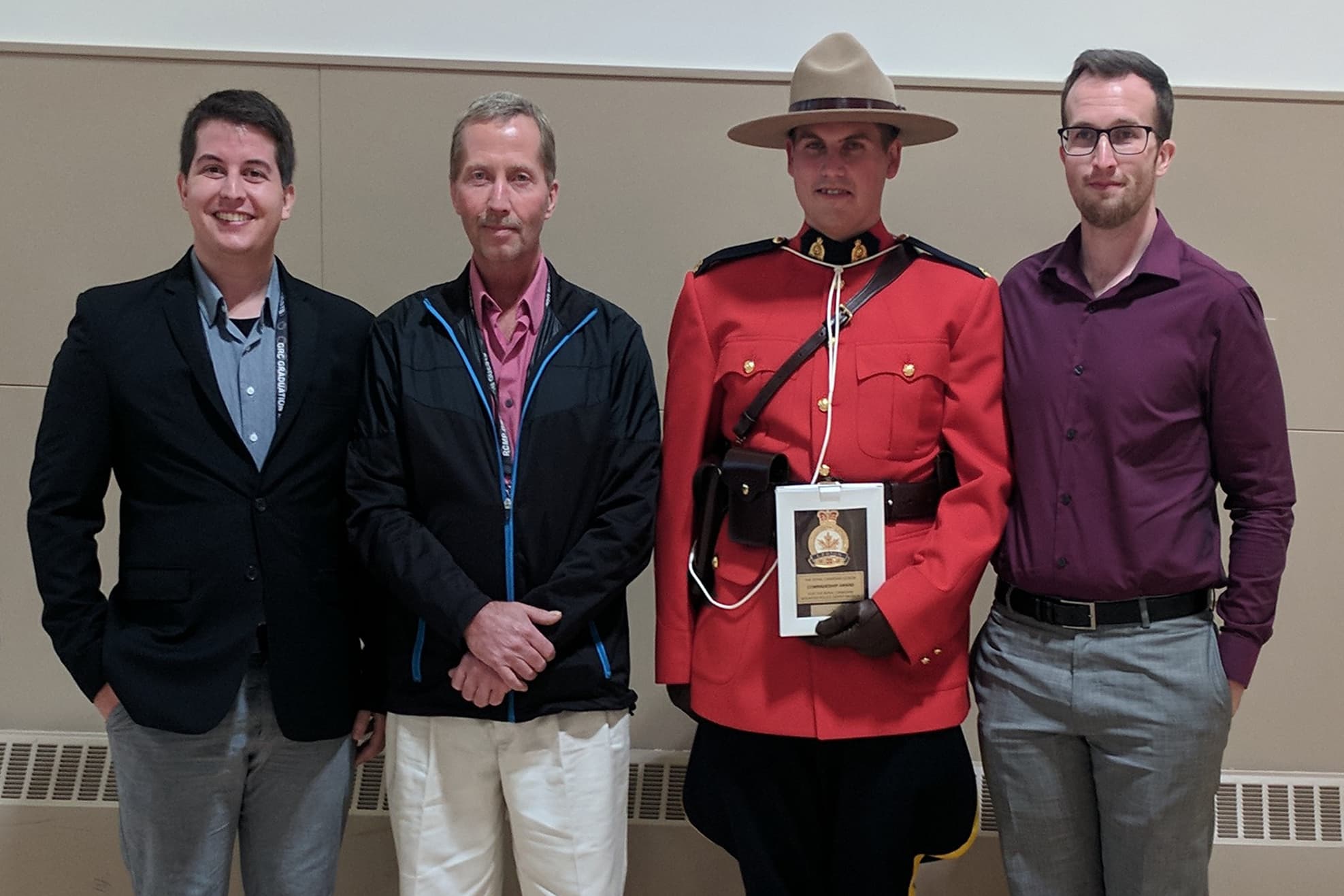 Brandon with his dad and brothers at an RCMP graduation ceremony