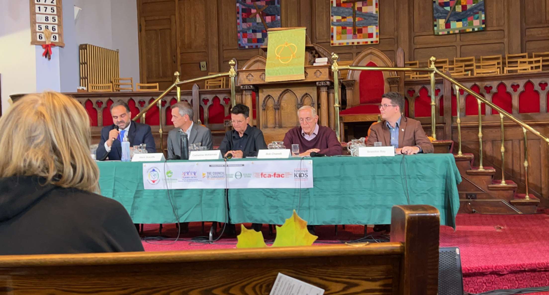 Brandon Bay speaking at a mayoral forum, 2022