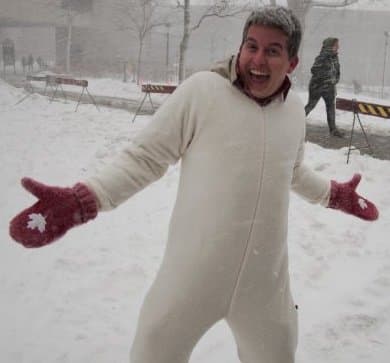 Brandon raising awareness in a white onesie, outside in the snow at uOttawa