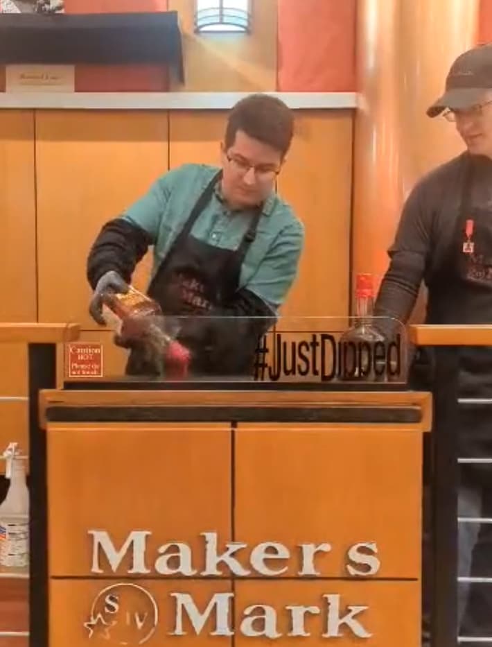Dipping my ambassador bottle of Maker's Mark into hot wax