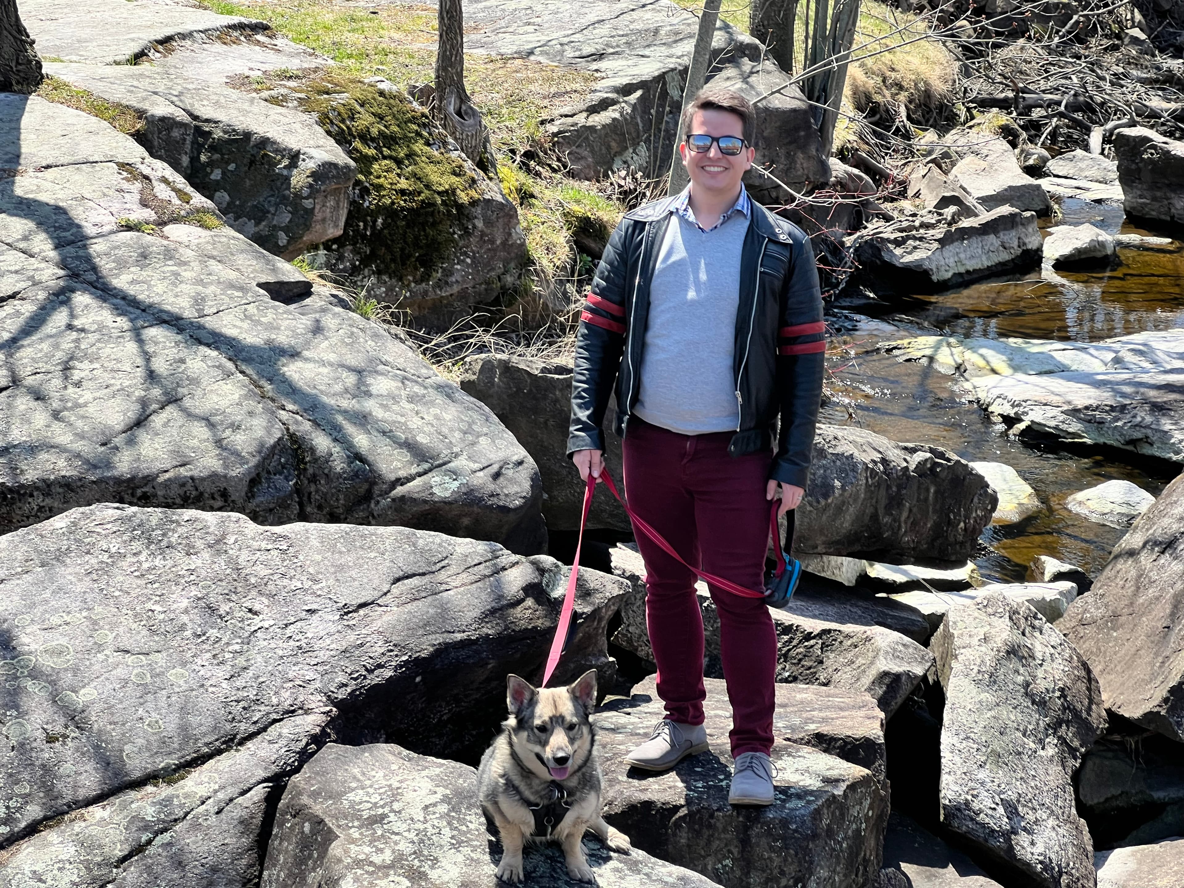 Brandon Bay with his dog, Timber, on the rocky shore of the Tay River in Perth, Ontario