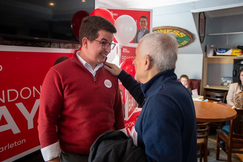 Brandon Bay speaking with a constituent at a Carleton campaign event
